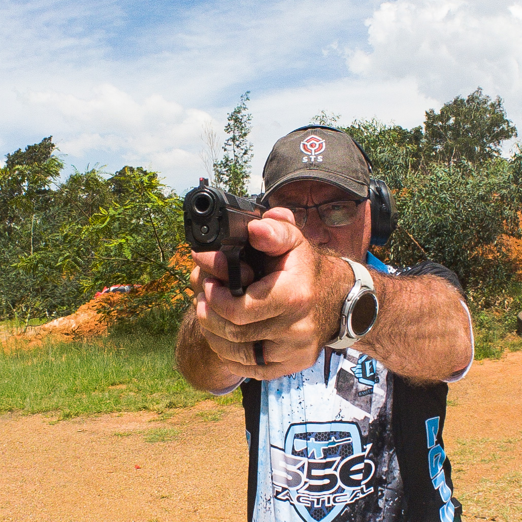 A man holding a gun, facing the camera