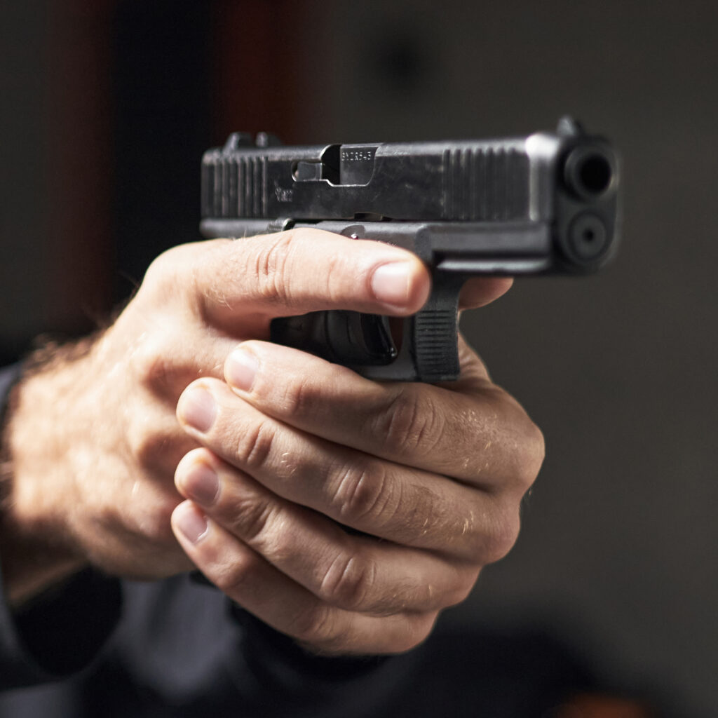 A close up of a handgun being aimed