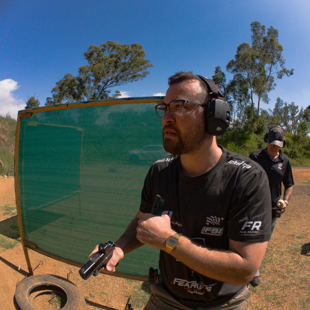 A shooting student in the process of making his firearm safe after shooting