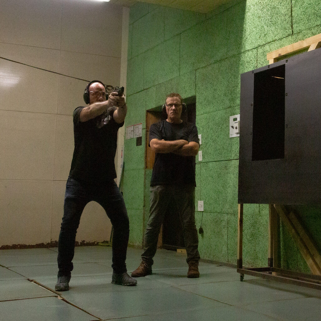 A Shield Tactical shooting instructor supervising a student