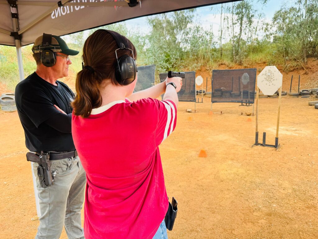 Shield tactical shooting instructor supervising a beginner at a shooting range in Germiston