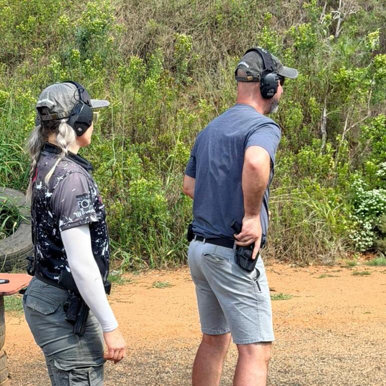 A Female Range Officer supervising a shooter
